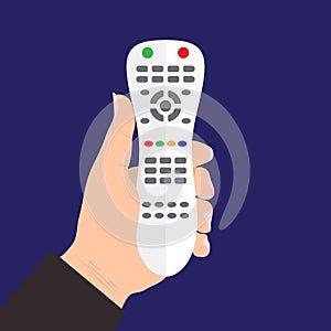 TV remote control device isolated in hand on blue background.