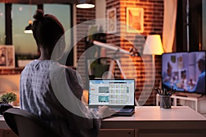 Remote accountant looking at company statistics on laptop screen