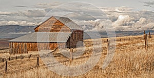 Remote barn with approaching storm clouds