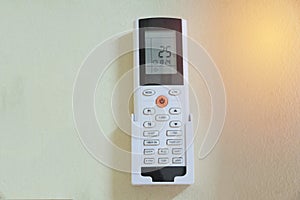 Remote control for air conditioner on the wall in room