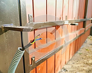 Remote control automatic electric gate install. Cable guide and wiring close up. Setup concept photo