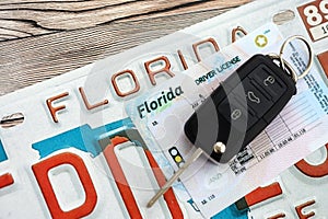 Remote control car keys on Florida license plate with driver license. Car driving in Florida