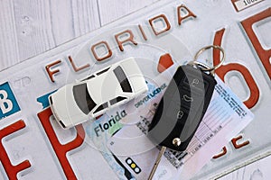 Remote control car keys on Florida license plate with driver license. Car driving in Florida
