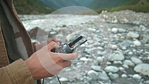 Remote control drone in the male hands of the pilot close-up. Man navigation flying drone with remote control. Man in