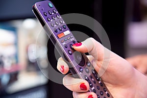 Remote control for satellite receiver box smart tv hd with microphone and voice control.. female finger push bottom. background in