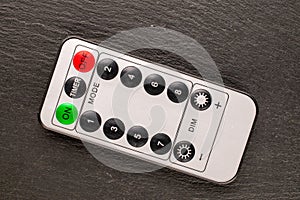 One remote on a slate rock , macro shot, top view.