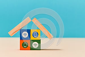 Remote control via smartphone. Smart home. Online services. Copy space. Colourful wooden cubes on blue and white
