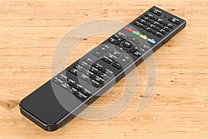 Remote control on the wooden table, 3D rendering