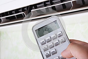 remote controllerair conditioner in hand