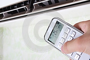 remote controllerair conditioner in hand