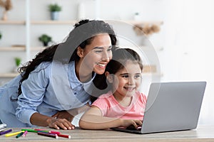 Remote Education. Mom And Little Daughter Using Laptop At Home Together