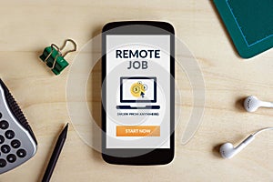 Remote job concept on smart phone screen on wooden desk