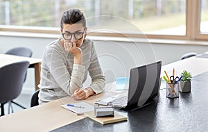 Bored woman with laptop working at home office photo