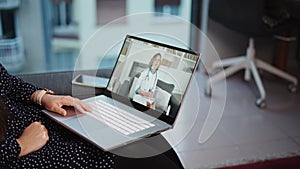 Remote medical care. Computer screen with young woman doctor consulting patient online