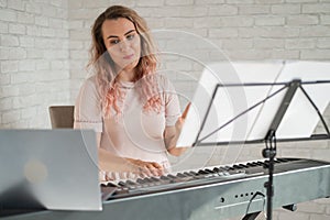 Remote music lessons. A singing teacher records the lesson on a laptop webcam.