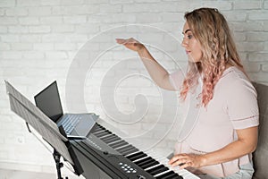 Remote music lessons. A singing teacher records the lesson on a laptop webcam. photo