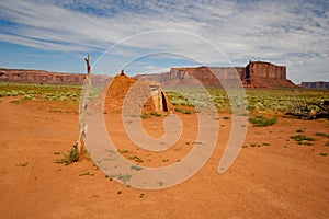 Remote Navajo Hogan Beside Old Deadwood Treestump in Monument Valley, Arizona