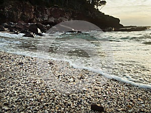 Remote rugged coastline, deserted exotic beach in early morning light