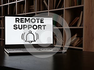 Remote support is shown using the text on the screen of laptop