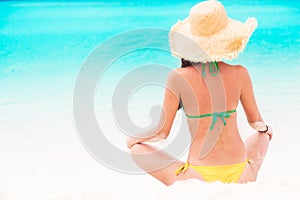 Portrait of long haired girl in bikini wearing red lips on tropical barbados beach