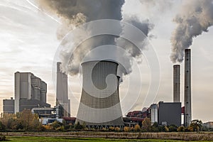 Remote view of a brown coal power plant with its cooling towers and chimneys