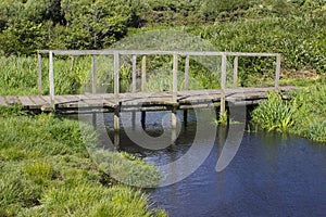 A remote wooden footbridge at the end of the Hook Lane bridle path near Titchfield Common England