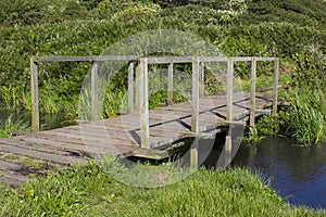 A remote wooden footbridge at the end of the Hook Lane bridle path near Titchfield Common England