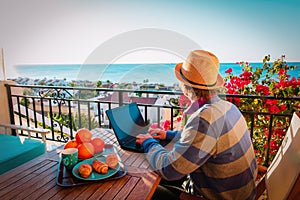 Remote work concept- young man with laptop on scenic terrace