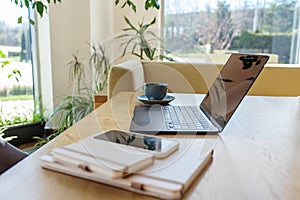 Remote Work Setup with Laptop, Coffee, and Smartphone