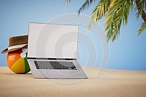 remote work on vacation. a laptop next to an inflatable ball in a hat on a sandy beach. 3D render