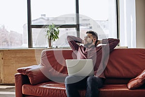 Remote work. Young man working at computer at home