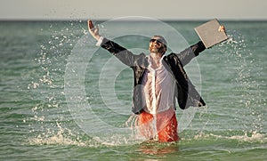 Remote workingbusinessman have fun at beach. happy businessman at sea. successful businessman on summer vacation. Summer