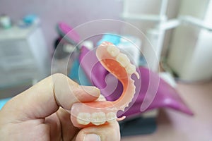 Removable denture in the hands of a doctor