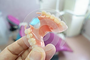 Removable denture in the hands of a doctor