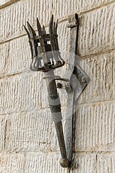 Removable iron torch on a medieval castle stone wall