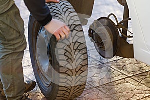 Removal of a car wheel and replacement of winter tires for summer