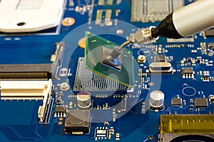 Removal of the chip by vacuum tweezers. Work on the disassembling of electronic components