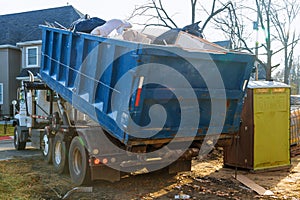 Removal of debris construction waste building demolition with rock and concrete rubble on portable bio-toilets