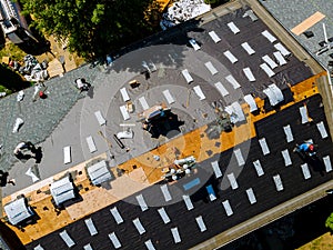 Removal of old roof and replacement roofs with new roof shingle being applied home roof construction all new materials