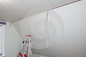 Removal of purple scotch tape from the ceiling after painting the walls
