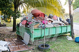 Removal rubbish dumpster bin with load of material for disposal