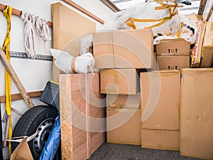 A removal van and cardboard boxes and packing materials.