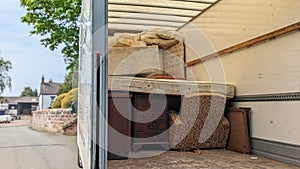 A removals van lorry filled with household furniture on side of road photo