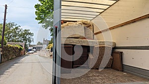 A removals van truck parked outside a house ready to fill photo