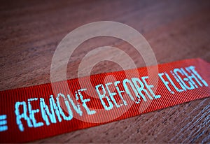 `Remove before flight` ribbon from pilot jacket background