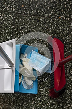 Remove masks and plastic gloves from the floor and throw them away into the bin