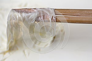 Remove milk skin from the surface of the milk with wooden sticks