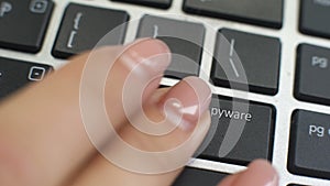 Remove spyware button on computer keyboard, female hand fingers press key