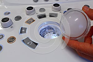 Removed trackball of modern diagnostic medical ultrasound scanner, optical element lights and electronics visible