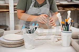 Removing air bubbles from clay before modeling to avoid the ruination of a ceramic product. Wedging the clay before